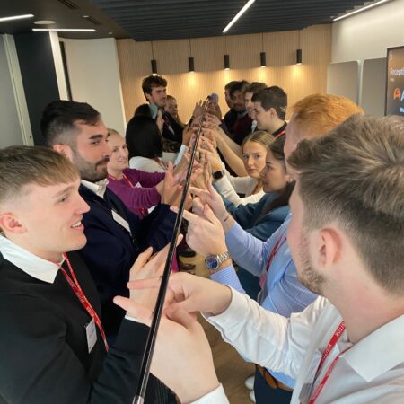 Helium pole team building activity with Hi5 leadership team development